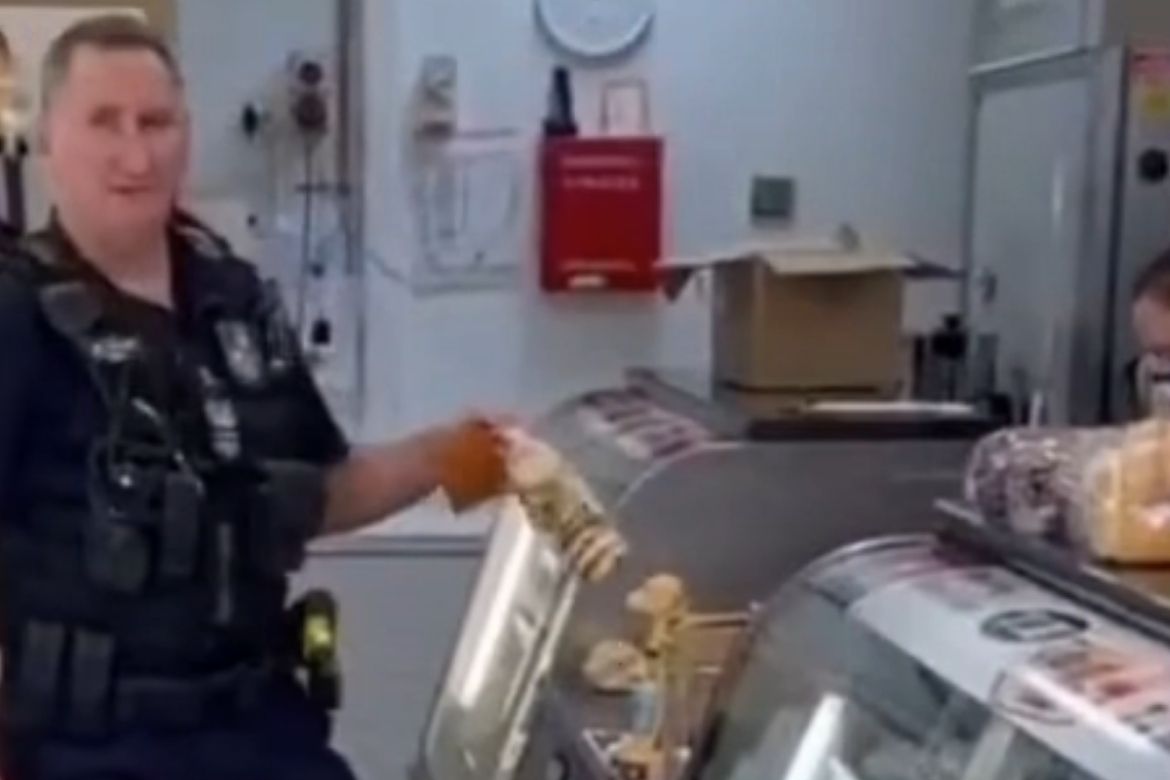 Unmasked police officer cops earful in Brisbane bakery