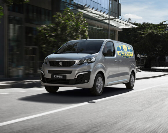 Peugeot Expert Van drives down suburban street