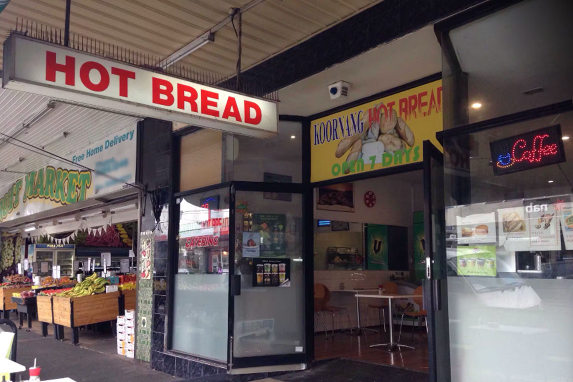 Street front of a small bakery, a sign reading HOT BREAD is hanging out the front (Koornang Hot Bread)