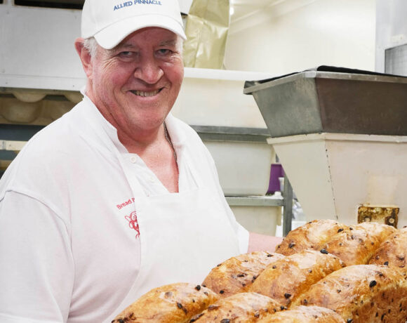 Stewart Latter holding a tray of bread loaves straight out of the oven