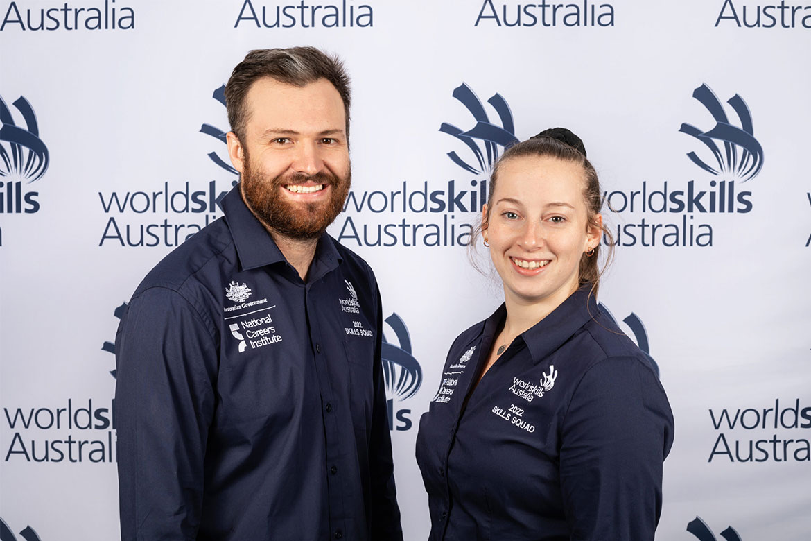 Fourth-place winner Rachel Crawford stands next to coach John Reminis in front of a WorldSkills Australia banner (WorldSkills Championship)