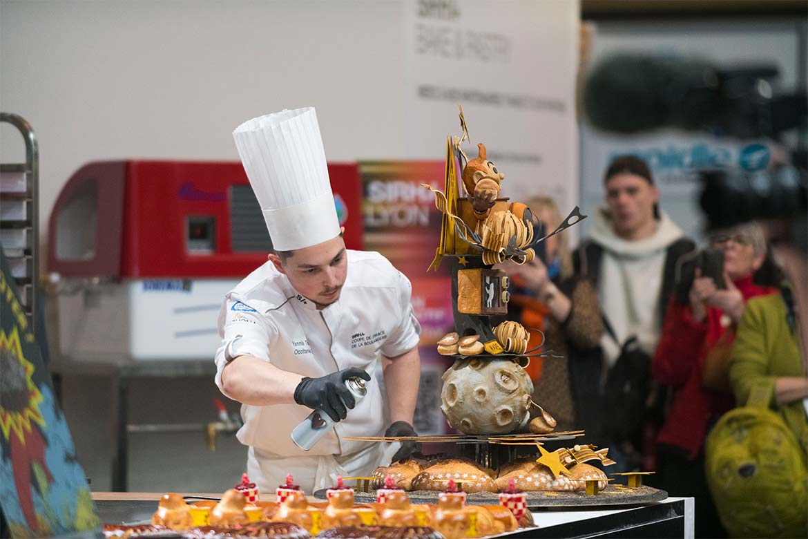 A chef works on his pastry sculpture under the theme of 'the conquest of space' (Sirha Lyon)