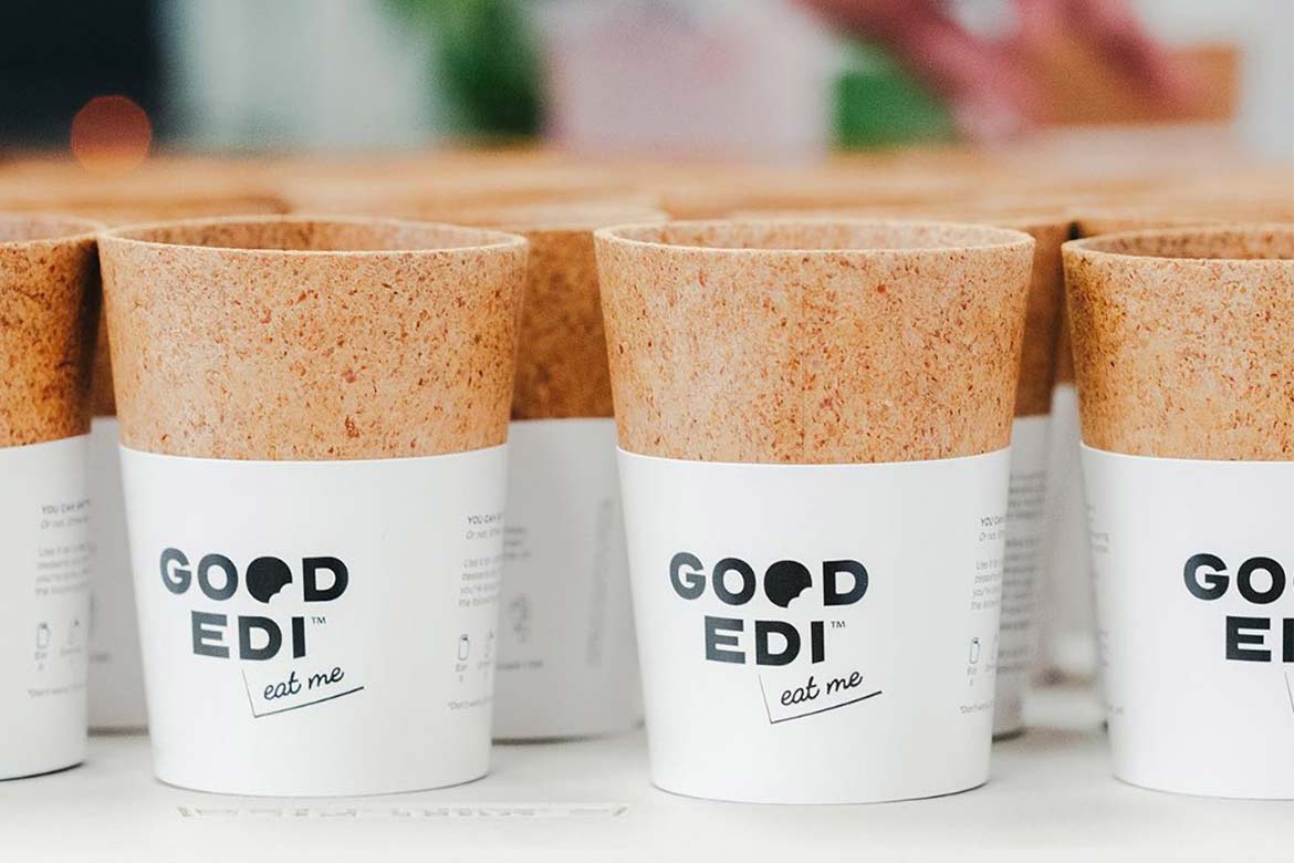 a row of Good-Edi coffee cups
