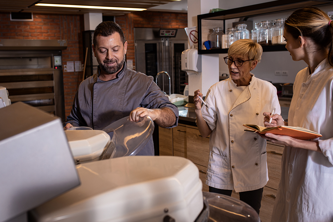 Bakers preparing dough for baking bread in modern manufacturing. (employee experience)