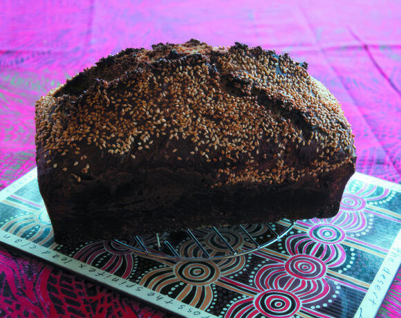 a loaf of bread made from native grains sitting on a table (first bakers)