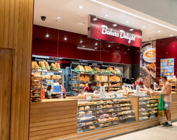 Exterior view of Bakers Delight bakery - a part of large Australian-owned bakery franchise chain with over 700 local outlets. Customer buying bread at local bakery.