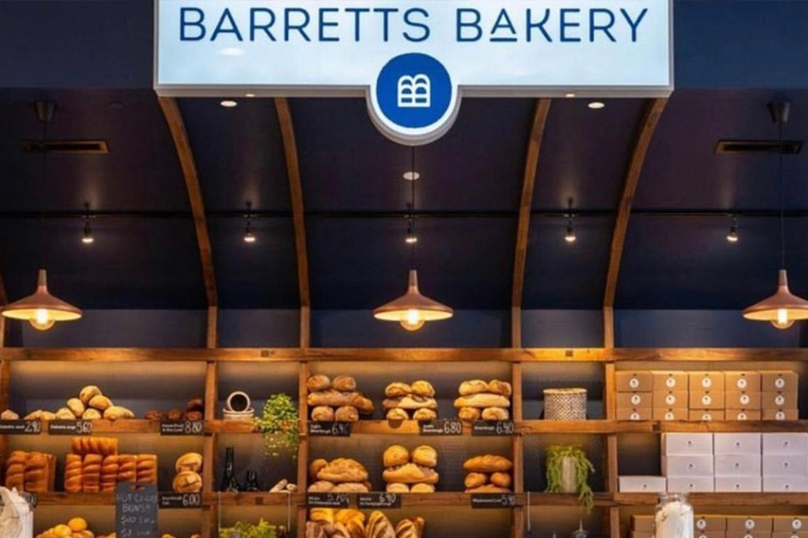 Barretts Bakery shopfront, signage at the top, shelves with baked goods in the background