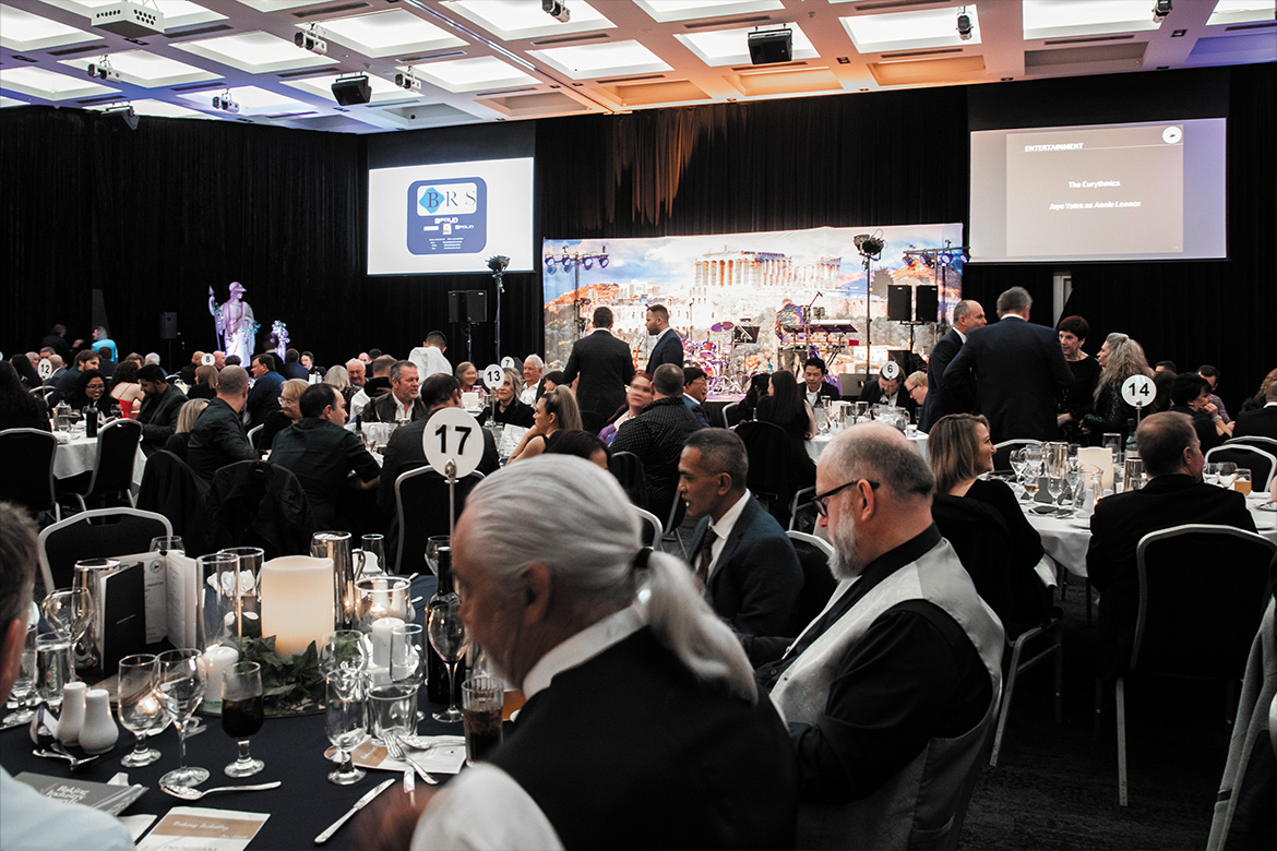 Room full of people sitting at dining tables (Award)