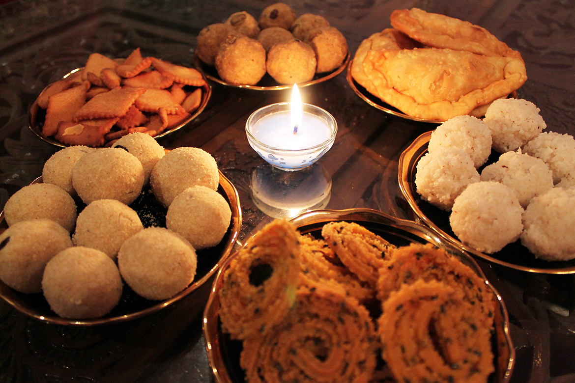 spread of Diwali food on a wooden table