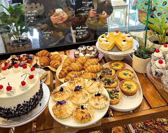 a spread of gluten free savoury and sweet treats in the window of Nutie