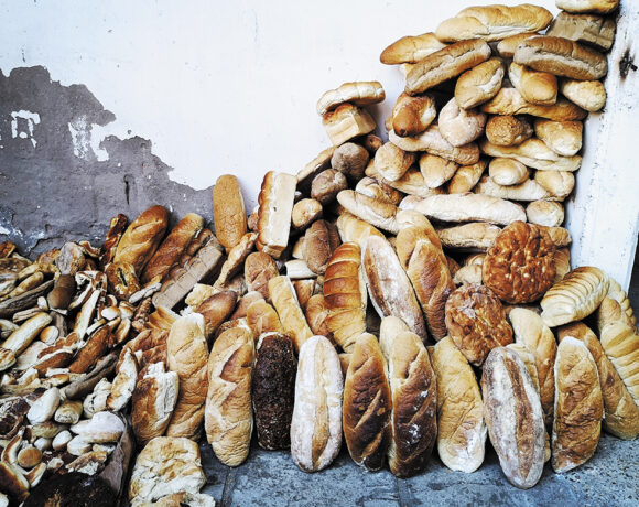 Pile of old loaves of bread against an outside wall (wastage)