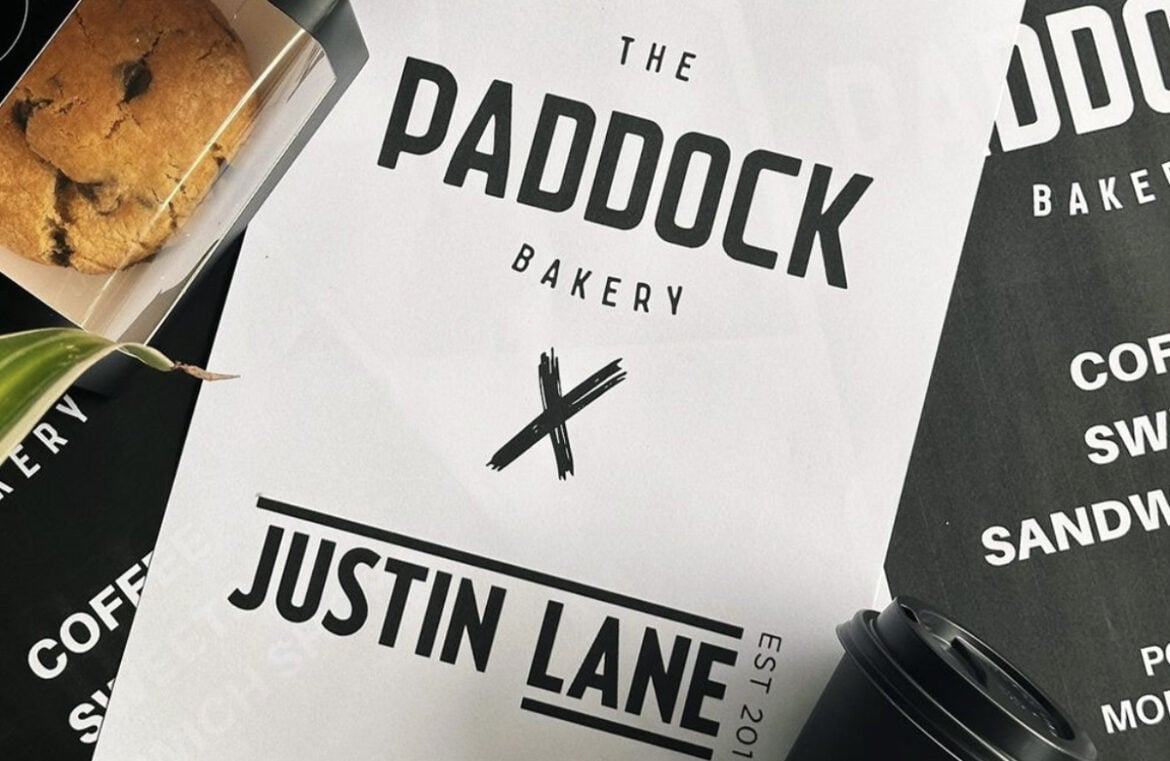 Paddock Bakery is hosting a pop-up shop in Fortitude Valley. Pictured is a sign that says Paddock x Justin Lane in black text on a white sheet of paper.