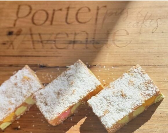 Three New Zealand rectangular lolly cakes on a cutting board branded with the bakery name, Porter Avenue.