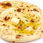 Garlic butter naan has taken out the top spot in TasteAstlas' top 100 breads list