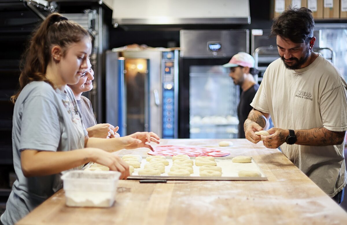 Robby in the bakery with his staff