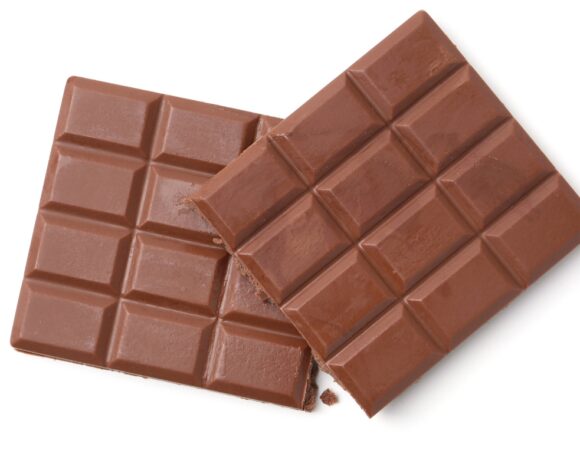 A chocolate bar has been made using 100 per cent British ingredients, including cocoa. Pictured is a large block of chocolate against a white background.